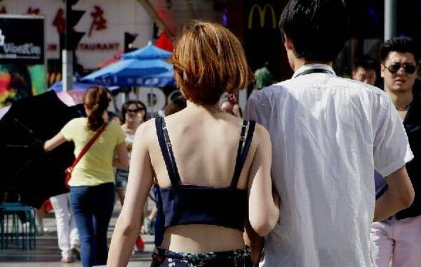 北京高温，姑娘们各种清凉装扮出街，内衣外穿最抢眼。（图片来源：新华网，十三虎/摄）