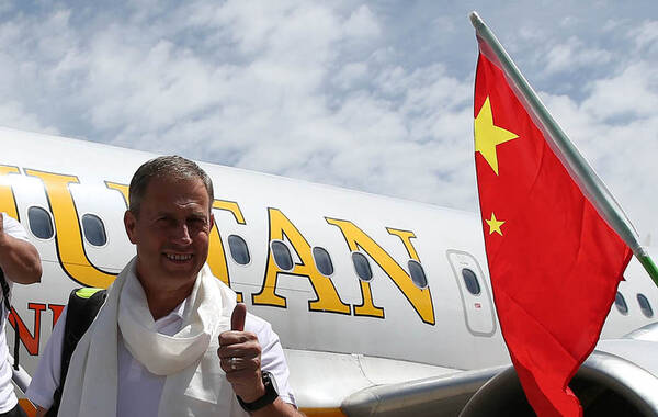 2015年6月14日，中国男足抵达不丹，众将机场与球迷合影武磊忙拍照。