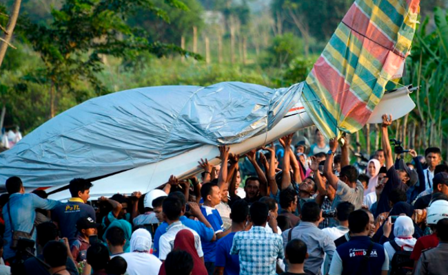 印尼官员驾机故障迫降 村民合力抬飞机