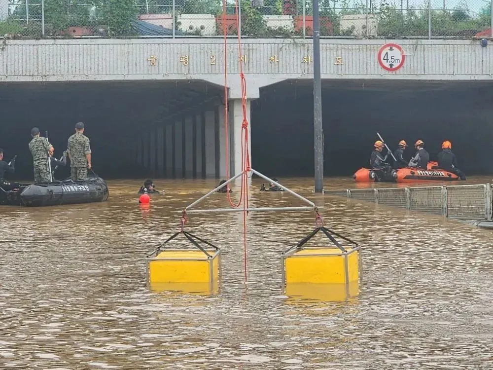 7月16日，在韩国忠清北道清州市，救援人员在被水淹没的地下车道进行搜救工作。新华社/纽西斯通讯社