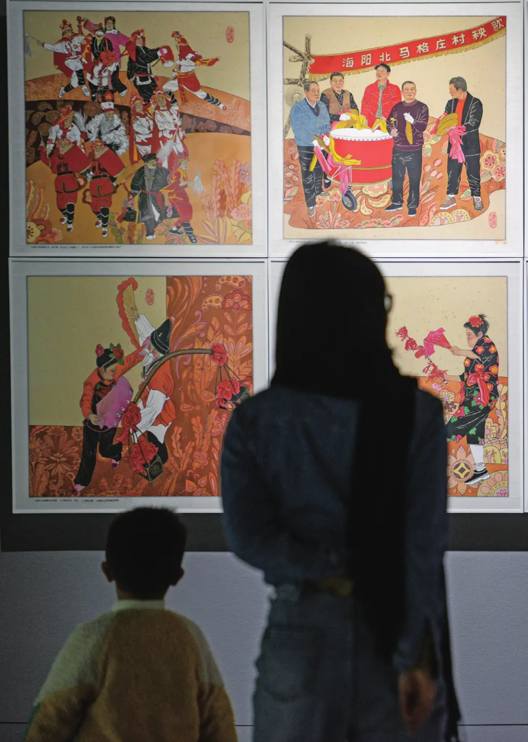 2023 年2月22日，重庆。一对母子正在重庆美术馆观看连环画展。（图/何蓬磊 中新社 ）