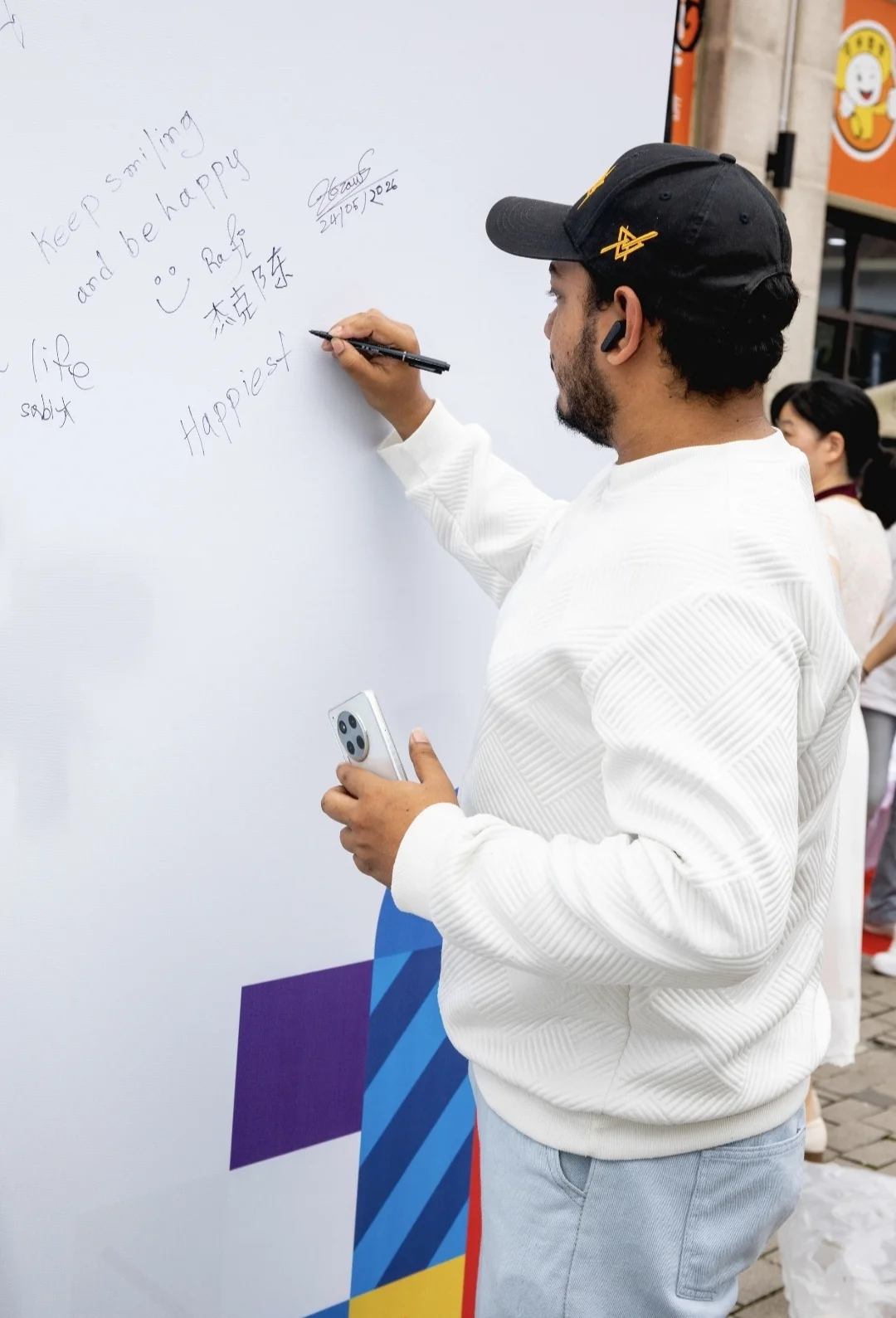 外国留学生在大师工作坊的背景板上写上了自己的名字。