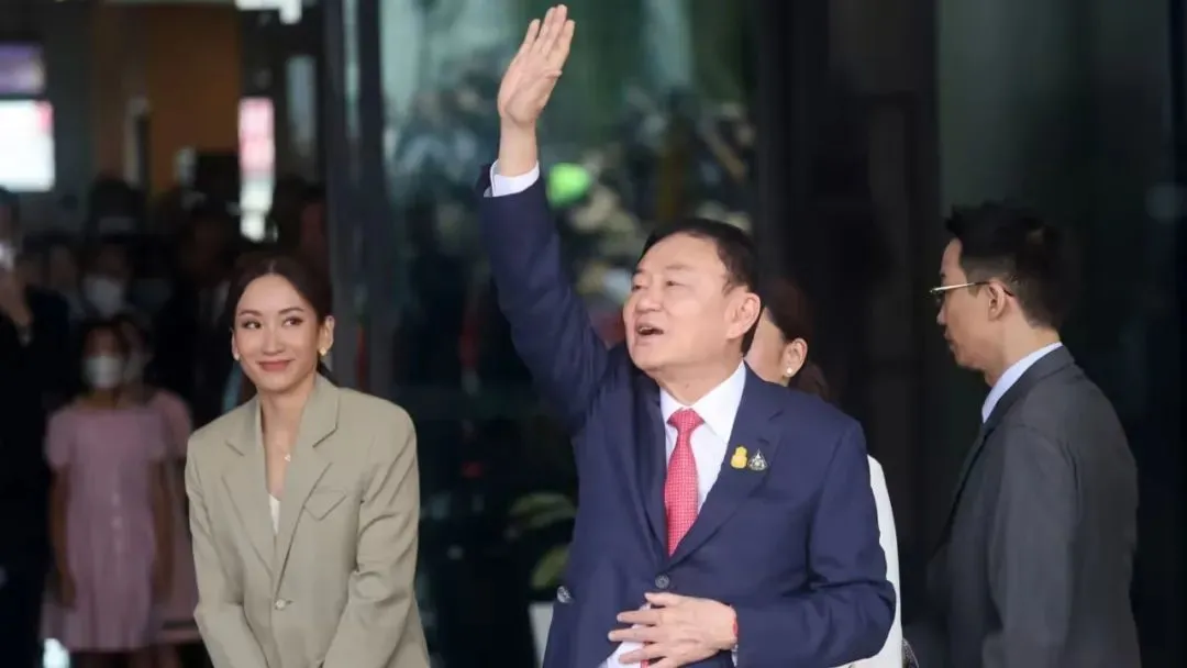 ◆8月22日，泰国前总理他信抵达曼谷机场，向民众打招呼。旁边是他的小女儿佩通坦。