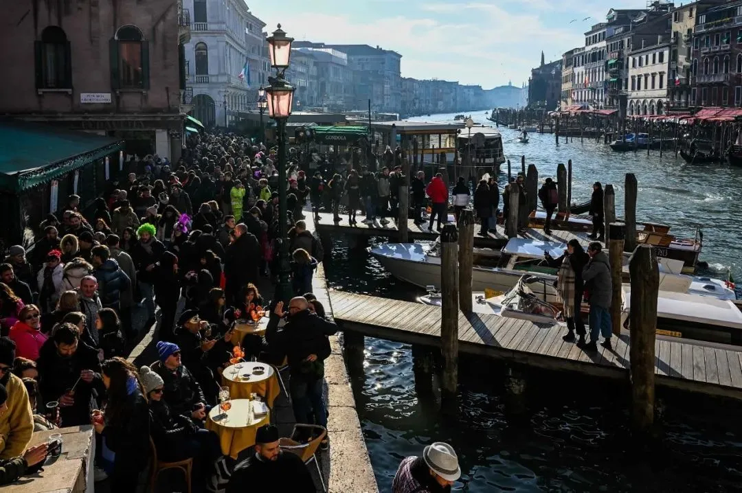 △威尼斯狂欢节期间，游客聚集在大运河旁。（图/视觉中国）