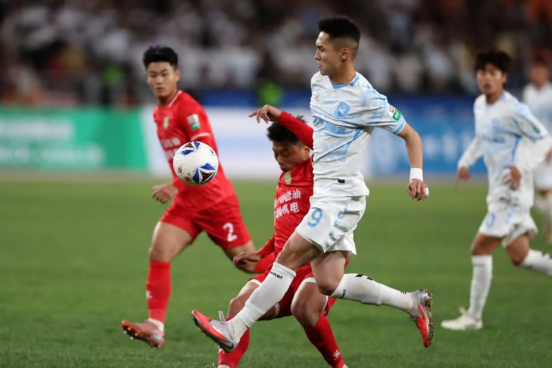 4月5日，兰州陇原竞技天佑德队球员乌拉尔&middot;木合塔尔（右二）在比赛中进攻。新华社记者　陈斌　摄