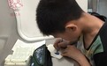 男孩趴在地铁车厢写作业 乘客拍照称其“一股清流”