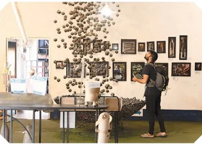 图为七月十一日，一名男子在老挝万象一展馆里观看模拟美军散布集束弹药的展品。