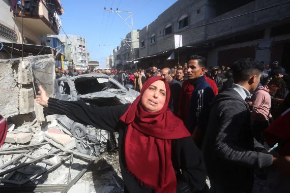 2月24日，在加沙地带南部城市拉法，人们聚集在被以军空袭的建筑前。新华社