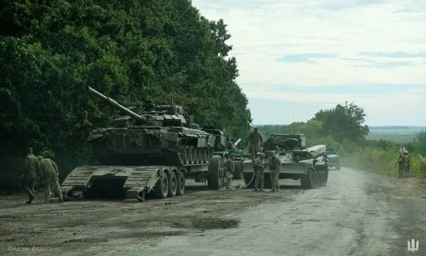 Ukrainian service members prepare to transport a Russian tank captured in Kharkiv region in this handout picture released by the press service of the commander-in-chief of the armed forces of Ukraine.