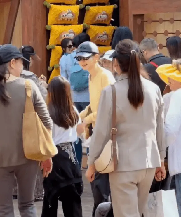 戚薇带孩子逛游乐园。