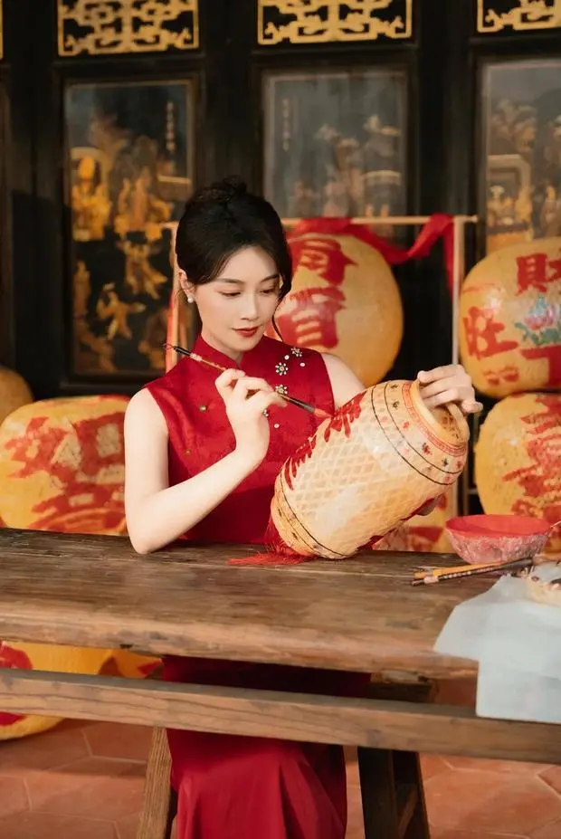 蓝盈莹神情专注，认真地在灯笼上写字。