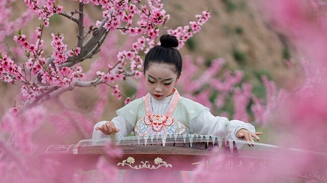 万亩桃林粉作云　花间笑语迎客来