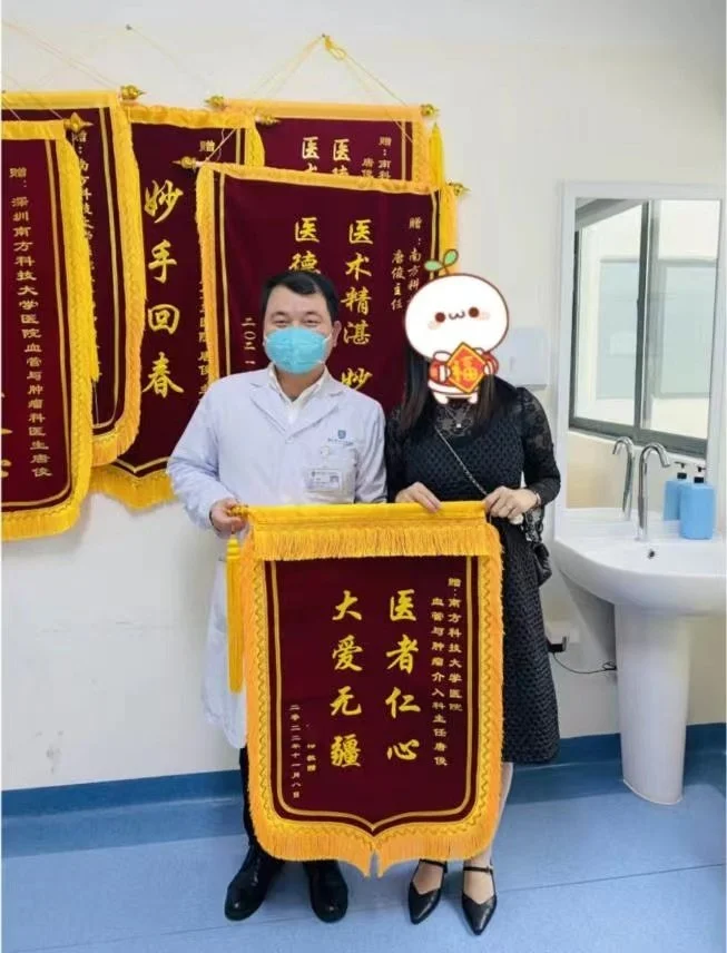 ▲吴女士为唐俊主任赠送锦旗。