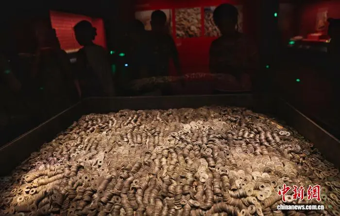 8月31日，江西南昌，游客在南昌汉代海昏侯国遗址博物馆参观展出的大量五铢钱。暑假尾声将至，南昌汉代海昏侯国遗址博物馆热度不减。游客们利用假期最后的时光，前来感受穿越两千年的历史文化魅力。中新社记者 刘占昆 摄